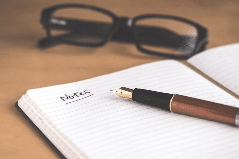 A notebook and pen in warm light