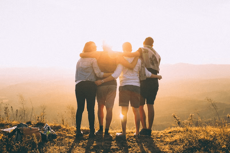 Friends arm in arm at golden hour
